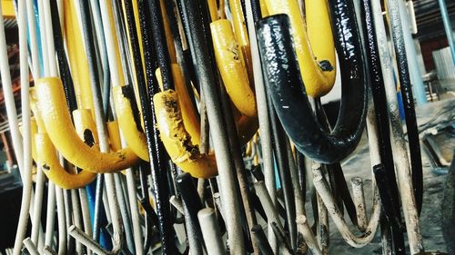 Full frame shot of yellow clothes hanging on metal