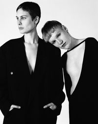 Young couple standing against white background