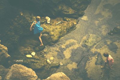 High angle view of woman standing on rock
