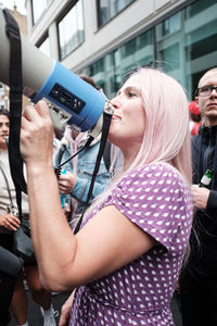 Portrait of woman holding camera