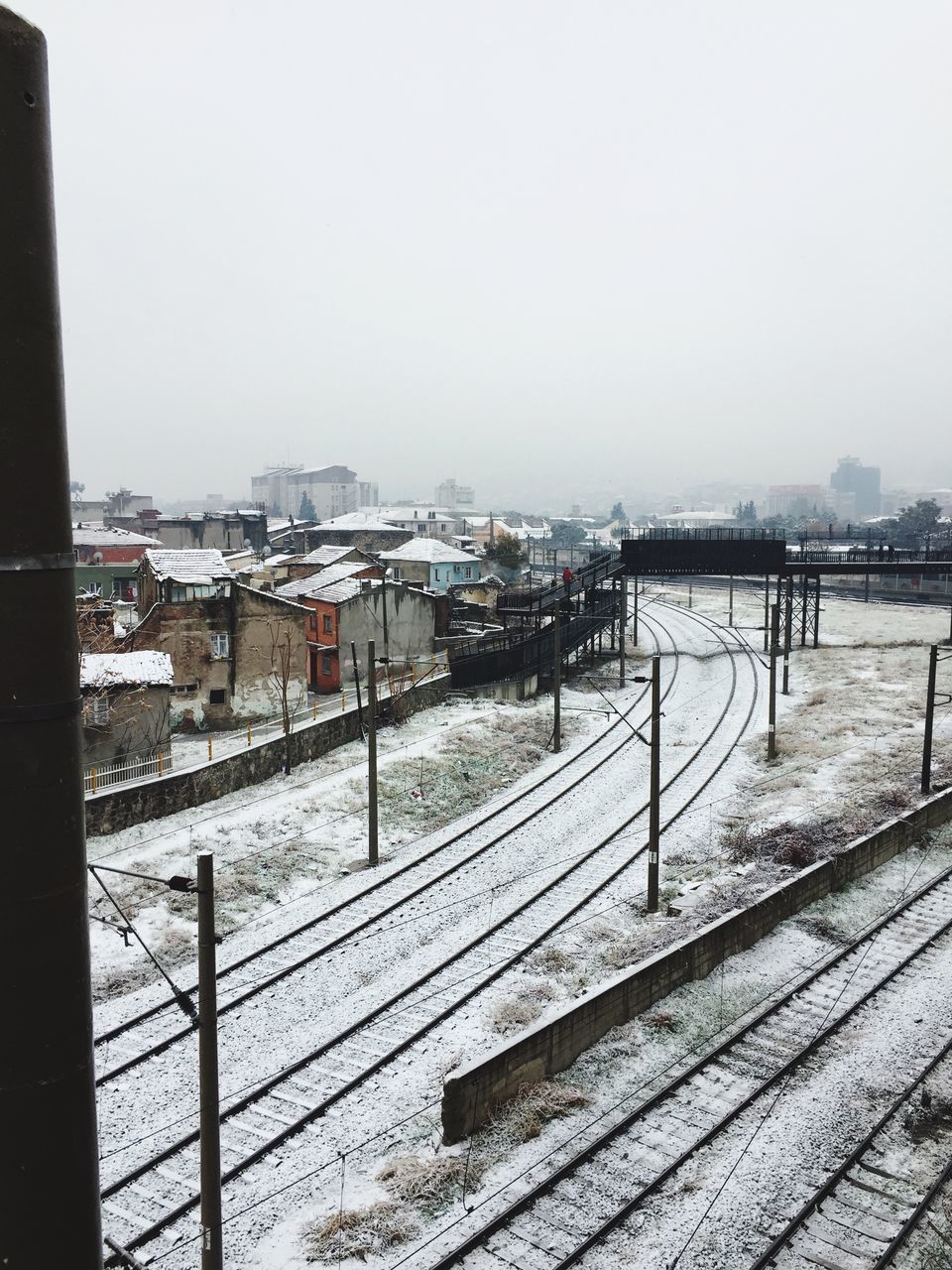 clear sky, transportation, architecture, built structure, rail transportation, nature, sky, day, railroad track, city, outdoors, no people, building exterior, cold temperature, snow, water, bridge - man made structure, connection