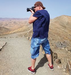 Full length of man photographing