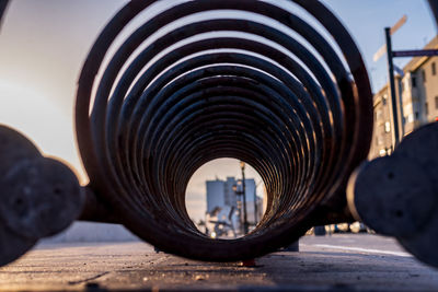 Close-up of machine part against sky