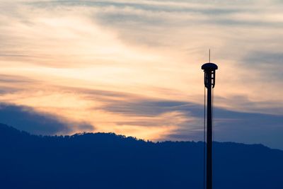 Low angle view of silhouette tower against sky during sunset