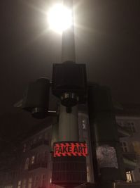 Illuminated lamp in city at night