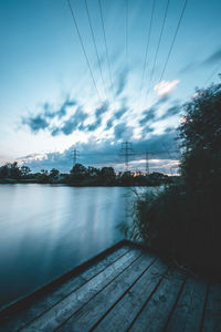 Scenic view of river against sky at dusk