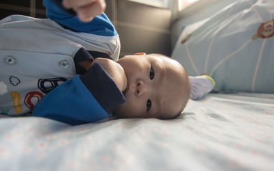 Cute baby lying on bed