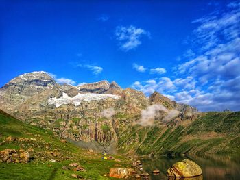 Scenic view of mountains against blue sky