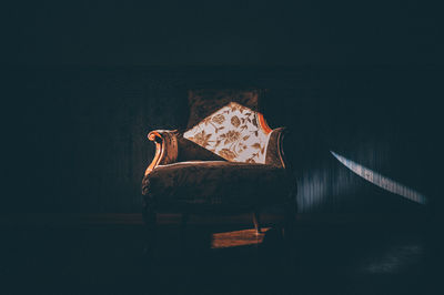 Low angle view of chair in darkroom