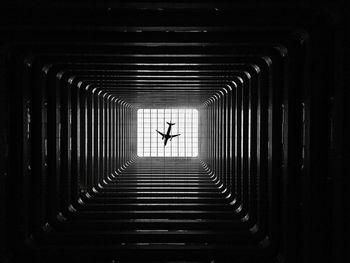 Silhouette of person in illuminated tunnel