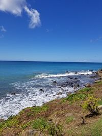 Scenic view of sea against blue sky