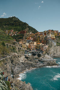 Aerial view of town by sea against sky
