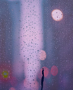 Close-up of wet glass window in rainy season