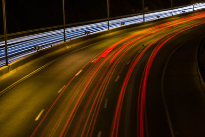 Light trails on bridge in city at night