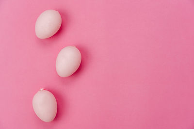 High angle view of pink petals on white background