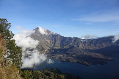 Smoke emitting from volcanic mountain against sky