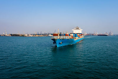 Aerial front view container cargo ship carrying commercial container import export business 