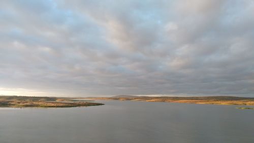 Scenic view of sea against sky at sunset