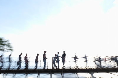 Low angle view of people against sky