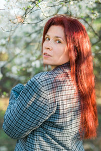 Portrait of young woman standing outdoors