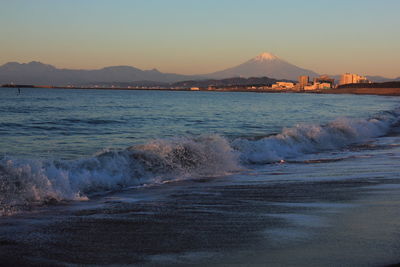 Calm sea against mountain range