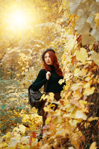 Young woman in autumn leaves