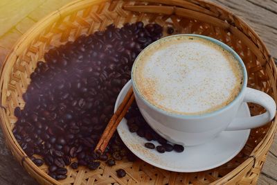 High angle view of coffee with roasted beans on table