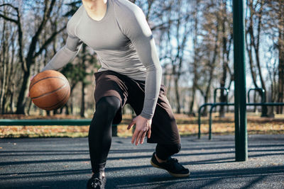 Woman playing basketball in park