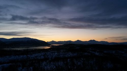 Scenic view of mountains against sky at sunset