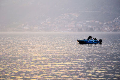 Man sailing on sea against sky