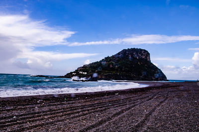 Scenic view of beach against blue sky