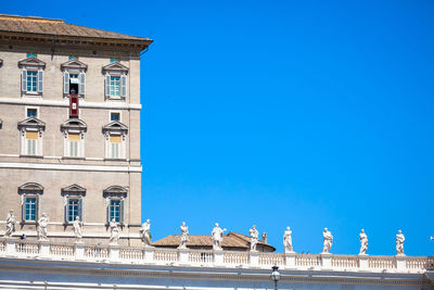 Low angle view of building against clear blue sky