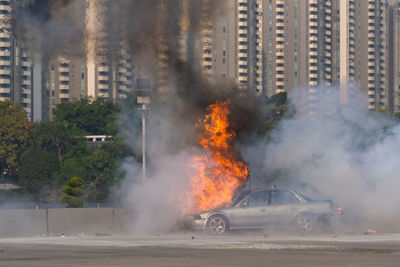 Car on street against buildings in city