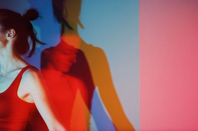 Close-up of woman standing against multi colored sky