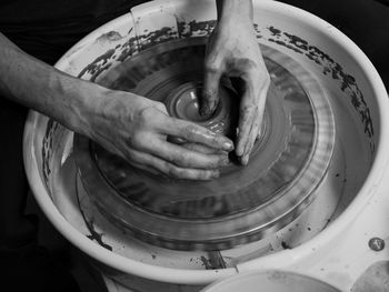 Cropped hand of person making clay pot