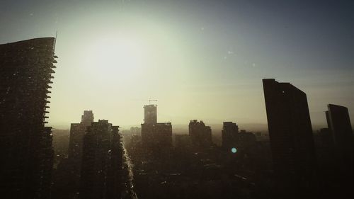 Skyscrapers in city at sunset