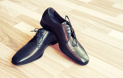 Close-up of shoes on wooden floor