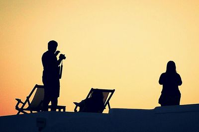 Low angle view of people at sunset