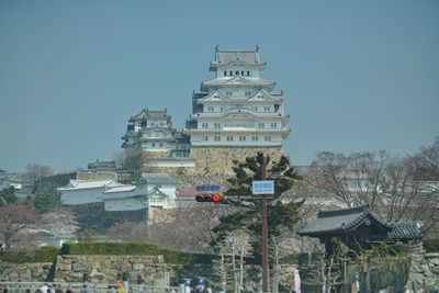 Buildings in city against clear blue sky