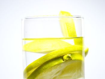 Close-up of yellow glass over white background