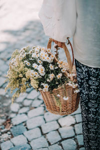 Midsection of woman holding bouquet