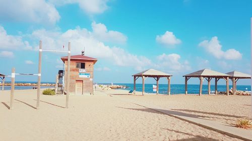 Lifeguard hut on beach against sky