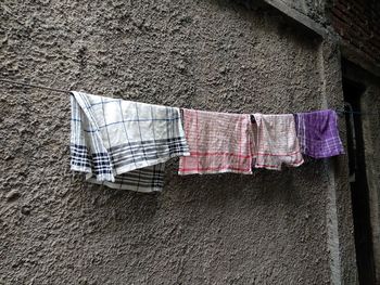 Clothes drying on clothesline against wall