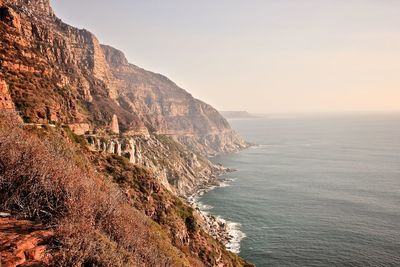 Scenic view of chapmans peak drive by sea against clear sky