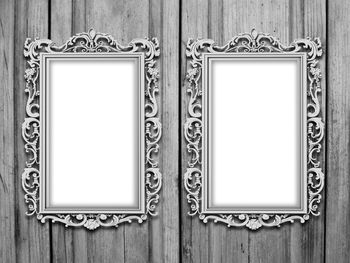 Blank picture frames on wooden wall