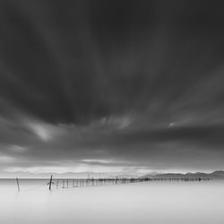 Long exposure shot of wooden sticks in the water, lake biwa, shiga prefecture, japan