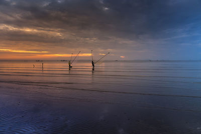 Scenic view of sea against sky at sunset