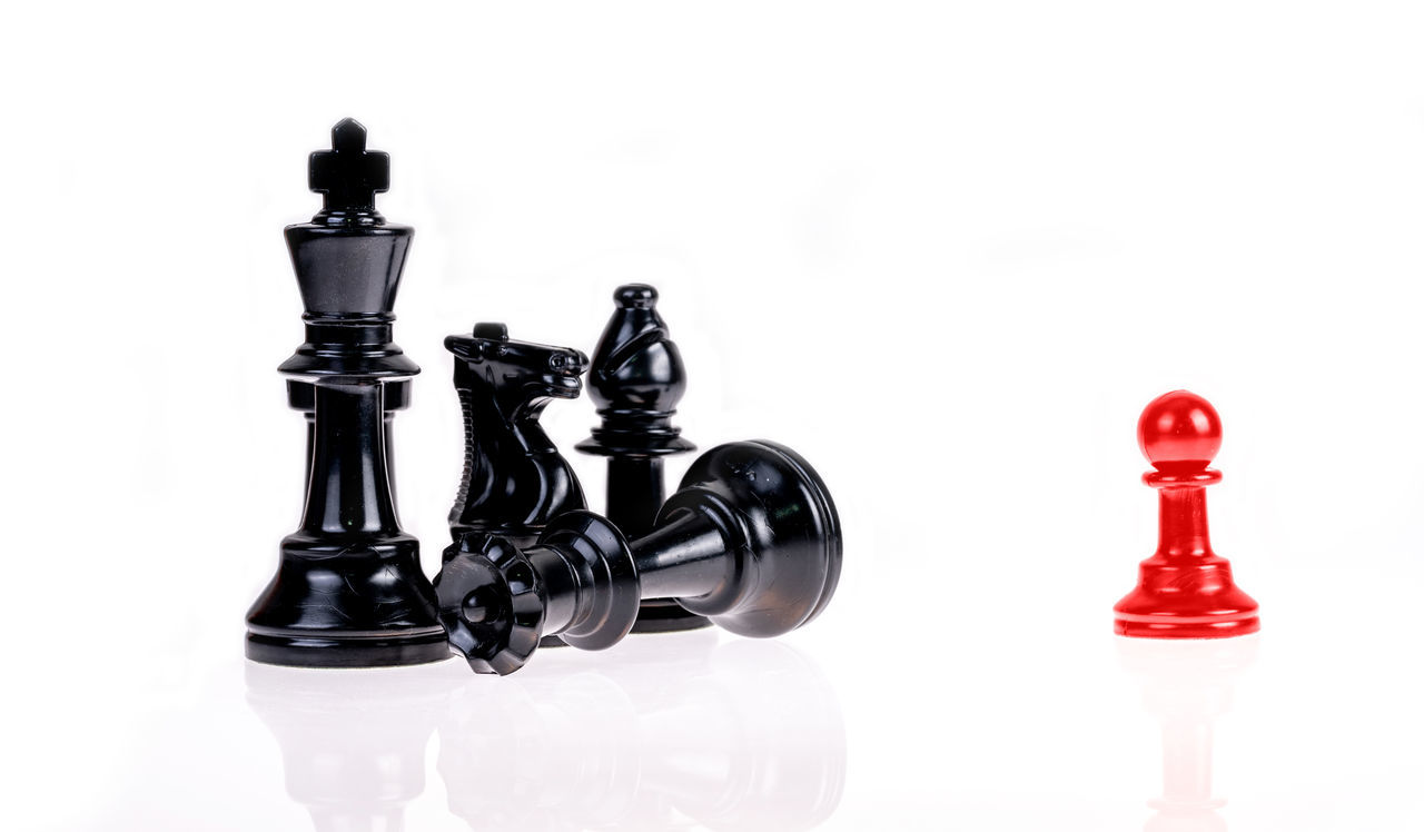 FULL FRAME SHOT OF CHESS PIECES AGAINST COLORED BACKGROUND