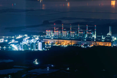 High angle view of illuminated buildings against sky at night