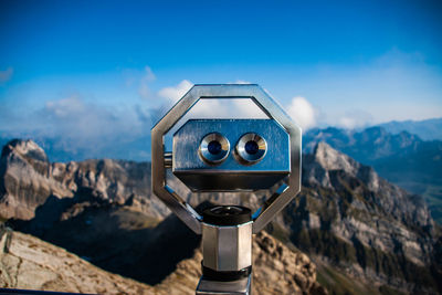 Close-up of camera on rock against sky